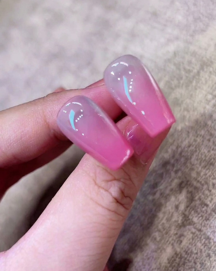 Una esponja presionando la punta de la uña para crear un suave degradado ombré en tono rosa.