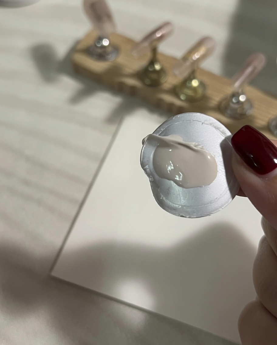 Una gota de pintura de gel blanca espesa aplicada sobre una paleta de mezcla de silicona blanca.