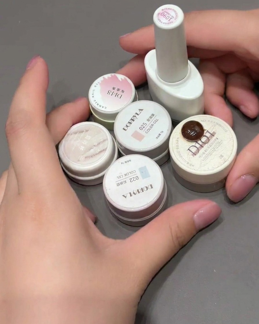 Una esponja de maquillaje dando toques sobre la punta de una uña para crear un difuminado degradado rosa.