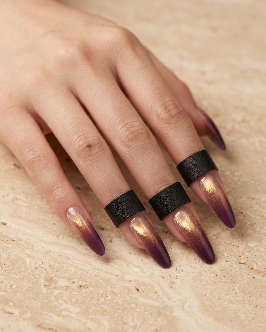 Primer plano de un pincel aplicando una fina capa de esmalte en gel morado en la punta de una extensión de uña transparente con forma de almendra.