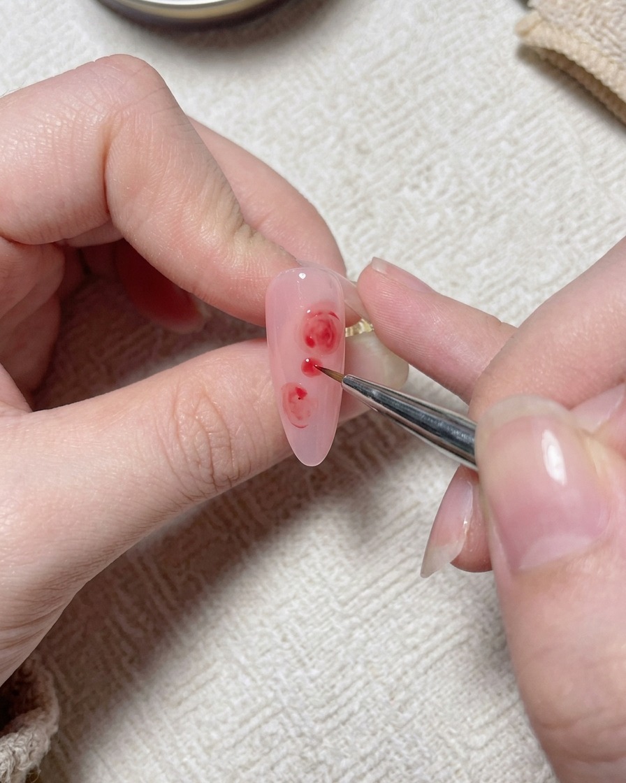 Un pincel fino aplica pequeños detalles blancos a toques sobre el diseño de la rosa rosa.