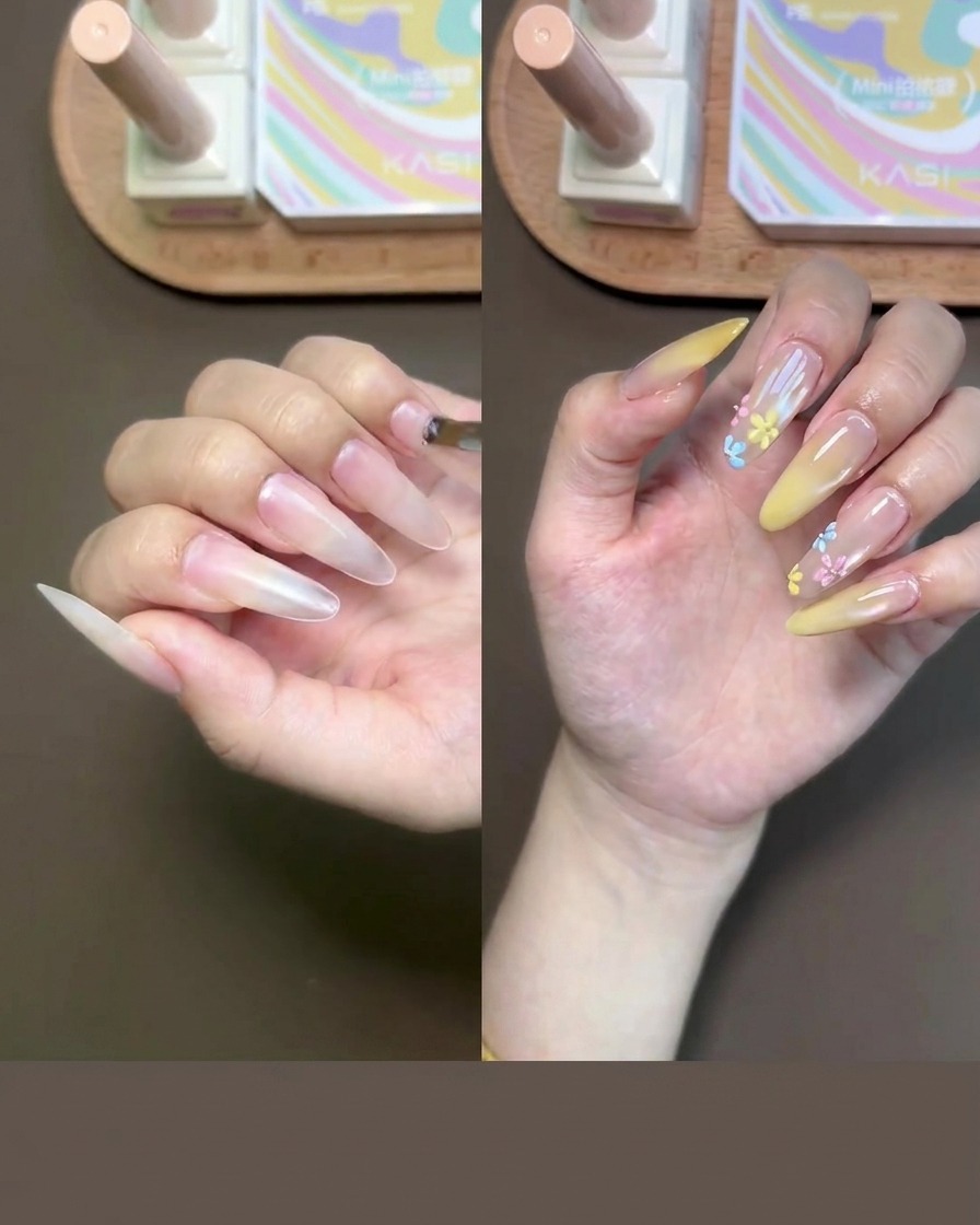 Primer plano de una mano recibiendo gel base nude en las uñas con un pincel pequeño.