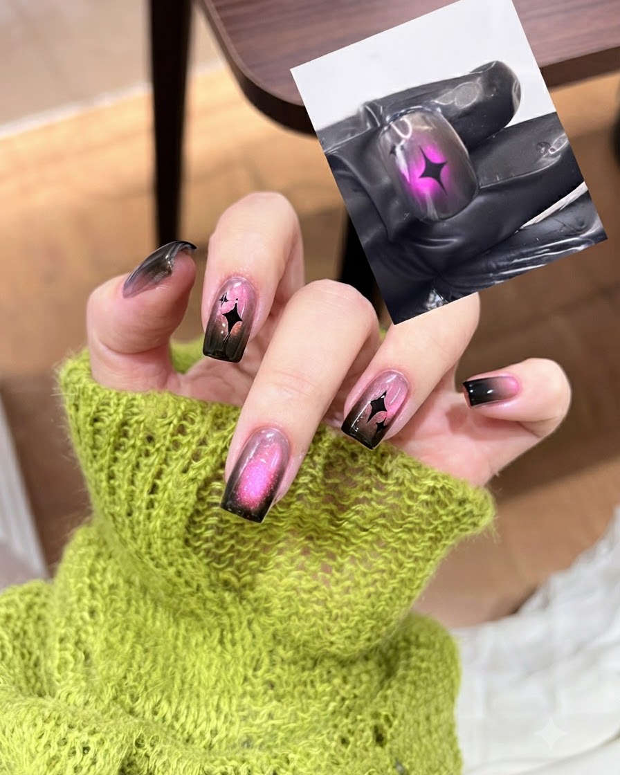 Un pincel de top coat aplicando una capa selladora transparente y brillante sobre un diseño de uña cat eye degradado en negro y rosa completo.