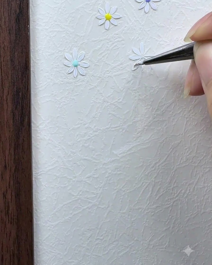 Un pincel de detalle pintando el segundo pétalo blanco directamente opuesto al primer pétalo.