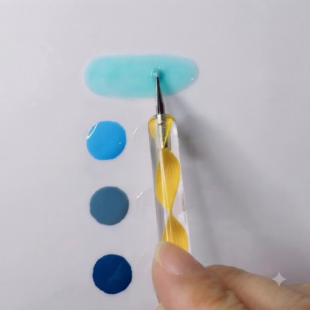 Un puntero difuminando un gel azul cielo vibrante con gel transparente formando un charco alargado y suave.